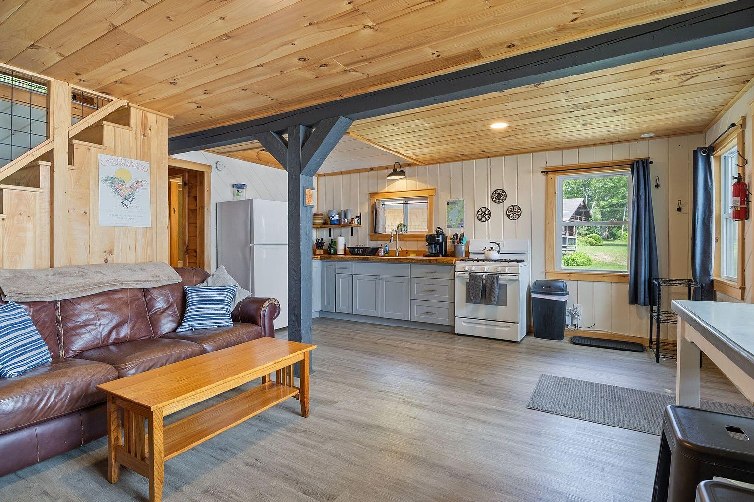 Interior bedroom with knotty pine walls and a small reading nook.